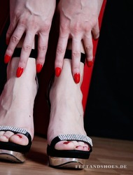 F&uuml;&szlig;e in silbernen Riemchen-Sandaletten mit rot lackierten N&auml;geln &ndash; FeetandShoes.de